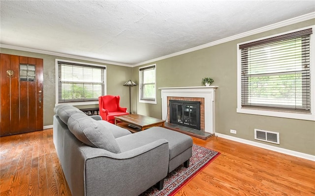 811 Jefferson Dr, Ross Twp, PA 15229 - living room with wood finished floors, a brick fireplace, crown molding, baseboards, and a textured ceiling