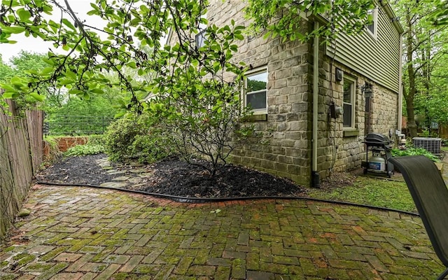 811 Jefferson Dr, Ross Twp, PA 15229 - view of side of home with fence, a patio, cooling unit, and stone siding