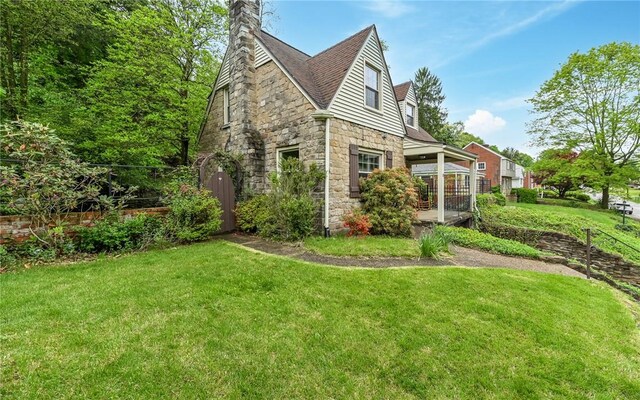 811 Jefferson Dr, Ross Twp, PA 15229 - view of property exterior featuring stone siding, a yard, and a chimney
