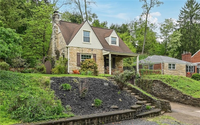 811 Jefferson Dr, Ross Twp, PA 15229 - view of front facade with stone siding, a porch, and a chimney
