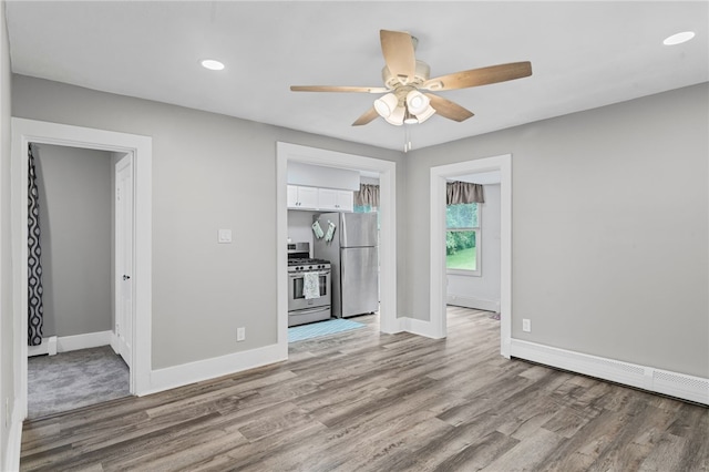 247 Pringle St, Banksville/Westwood, PA 15106 - unfurnished living room featuring ceiling fan, wood finished floors, baseboards, a baseboard heating unit, and recessed lighting