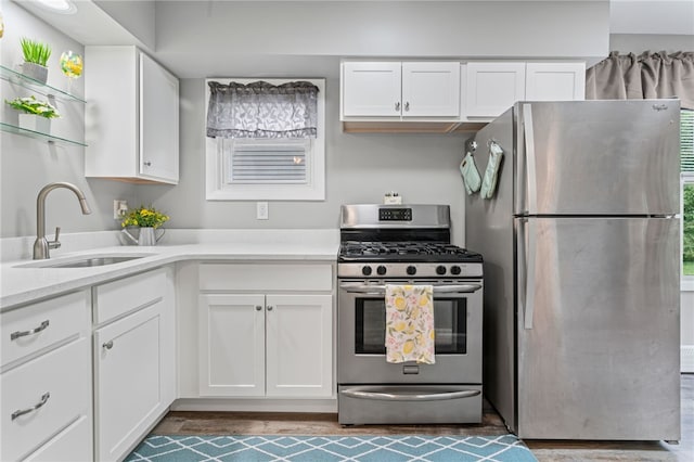 247 Pringle St, Banksville/Westwood, PA 15106 - kitchen featuring appliances with stainless steel finishes, a sink, white cabinets, light countertops, and wood finished floors