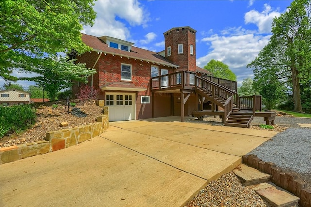 rear view of house featuring stairs, a patio area, a wooden deck, and brick siding
