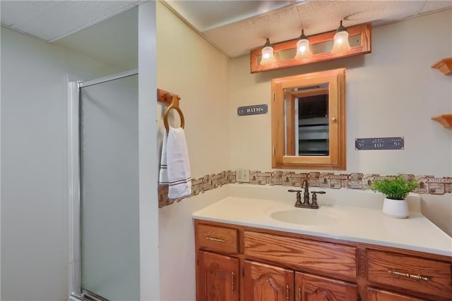 full bathroom featuring a stall shower and vanity