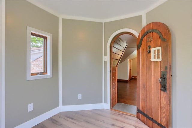 empty room featuring light wood-type flooring and baseboards