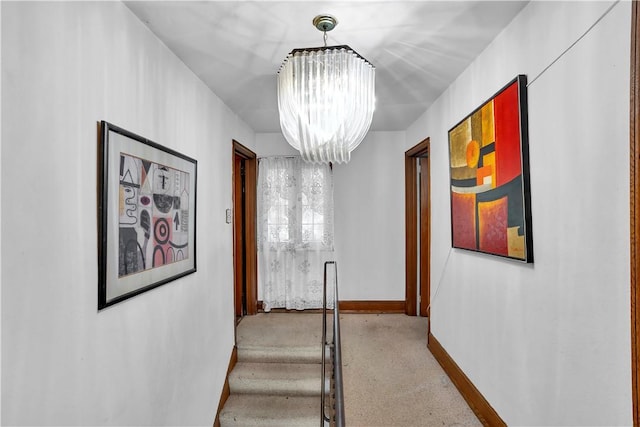 hall with a chandelier and baseboards