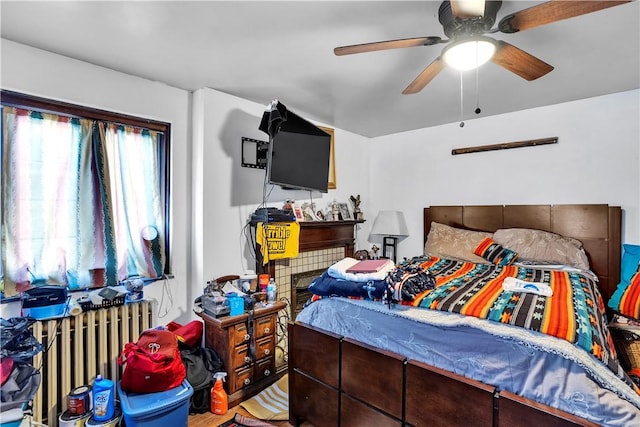 bedroom featuring ceiling fan and radiator heating unit