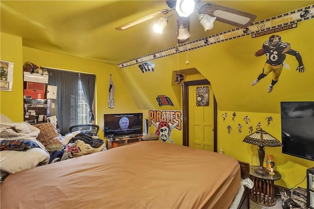 bedroom featuring lofted ceiling and a ceiling fan