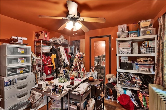 misc room with a ceiling fan and wood finished floors