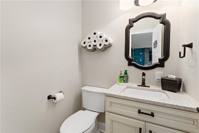 bathroom featuring toilet and vanity