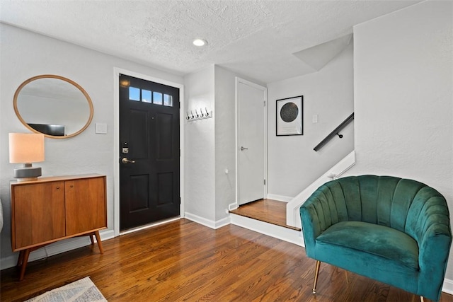 665 Dunster St, Brookline, PA 15226 - foyer entrance with a textured ceiling, wood finished floors, and baseboards