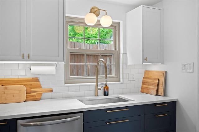 665 Dunster St, Brookline, PA 15226 - kitchen featuring stainless steel dishwasher, a sink, decorative backsplash, and white cabinetry