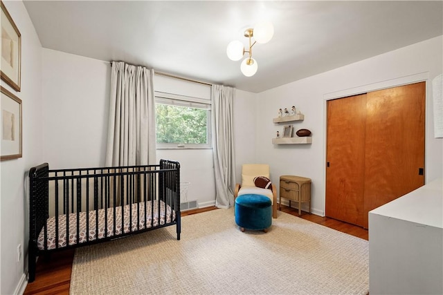 205 Seegar Rd, Upper St Clair, PA 15241 - bedroom with wood finished floors, baseboards, and a nursery area