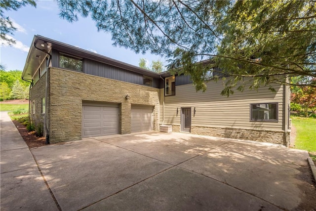 205 Seegar Rd, Upper St Clair, PA 15241 - view of front of home featuring stone siding, concrete driveway, and a garage
