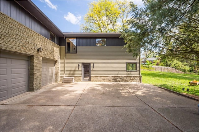 205 Seegar Rd, Upper St Clair, PA 15241 - back of house featuring stone siding, concrete driveway, a lawn, and a garage