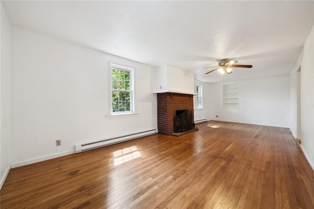 unfurnished living room with a baseboard radiator, hardwood / wood-style flooring, ceiling fan, and a brick fireplace