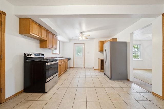 kitchen featuring appliances with stainless steel finishes, ceiling fan, baseboards, and light tile patterned flooring
