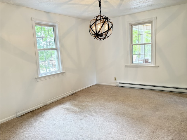 carpeted empty room featuring a chandelier, healthy amount of natural light, a baseboard radiator, a textured ceiling, and baseboards