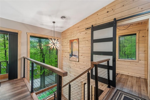133 Imperial Rd, Hidden Valley, PA 15502 - hallway featuring lofted ceiling, wood walls, hardwood / wood-style flooring, a chandelier, and an upstairs landing