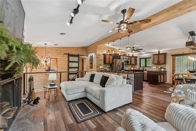 133 Imperial Rd, Hidden Valley, PA 15502 - living area with wood walls, a ceiling fan, a chandelier, and dark wood-style flooring