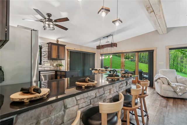 133 Imperial Rd, Hidden Valley, PA 15502 - kitchen with light wood-type flooring, ceiling fan, dark countertops, a kitchen breakfast bar, and hanging light fixtures