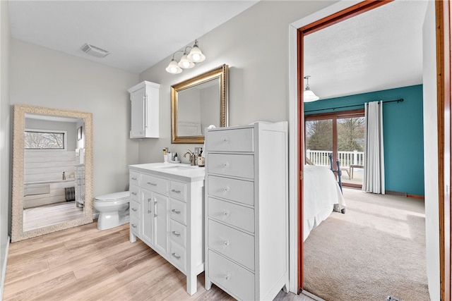 844 Old Millcreek Rd, Hookstown, PA 15050 - ensuite bathroom with toilet, vanity, and wood finished floors