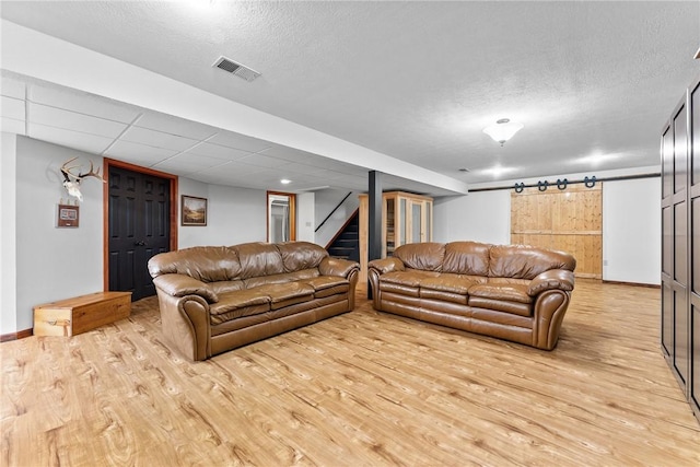 844 Old Millcreek Rd, Hookstown, PA 15050 - living area featuring light wood-style floors, stairs, a textured ceiling, and baseboards