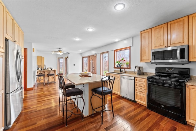 844 Old Millcreek Rd, Hookstown, PA 15050 - kitchen featuring stainless steel appliances, light brown cabinets, a kitchen breakfast bar, dark wood-type flooring, and recessed lighting