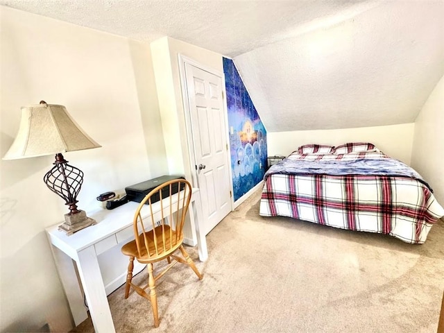 carpeted bedroom with a textured ceiling, vaulted ceiling, an office area, and baseboards