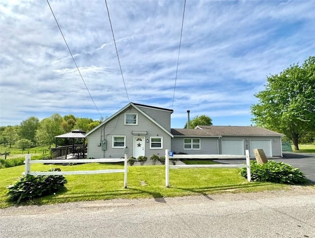 view of front of home featuring driveway, an attached garage, a front yard, and a gazebo