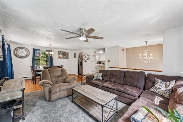 716 Stauffer Ave, Scottdale, PA 15683 - living room with a chandelier, a textured ceiling, wood finished floors, ceiling fan, and a baseboard radiator