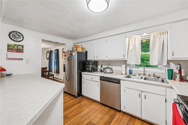 716 Stauffer Ave, Scottdale, PA 15683 - kitchen featuring appliances with stainless steel finishes, a sink, a textured ceiling, light countertops, and light wood-style flooring