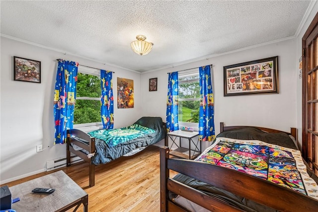 716 Stauffer Ave, Scottdale, PA 15683 - bedroom with a baseboard heating unit, a textured ceiling, wood finished floors, and ornamental molding