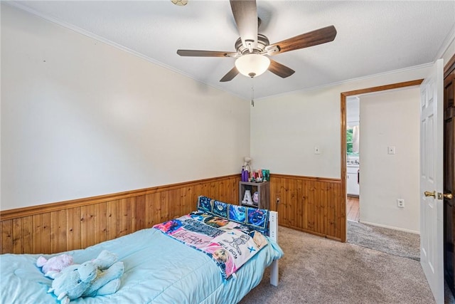 716 Stauffer Ave, Scottdale, PA 15683 - carpeted bedroom with wooden walls, a wainscoted wall, ceiling fan, and crown molding