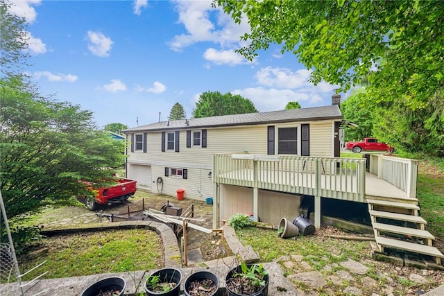 716 Stauffer Ave, Scottdale, PA 15683 - back of property with a deck, a chimney, and a garage
