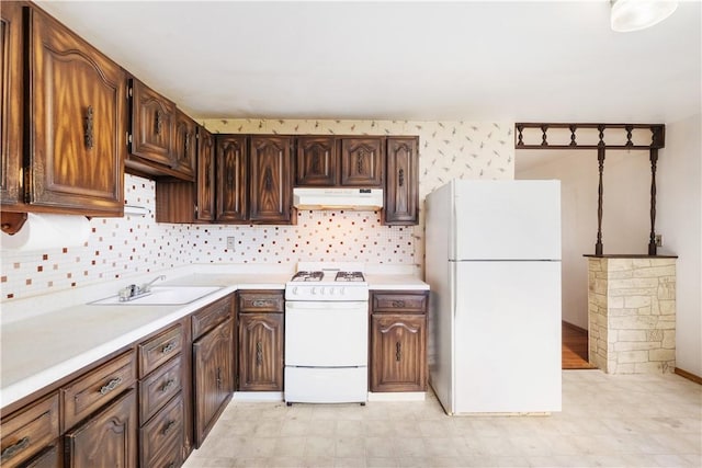 601 Dressel Rd, Shaler, PA 15101 - kitchen featuring white appliances, under cabinet range hood, a sink, and light countertops