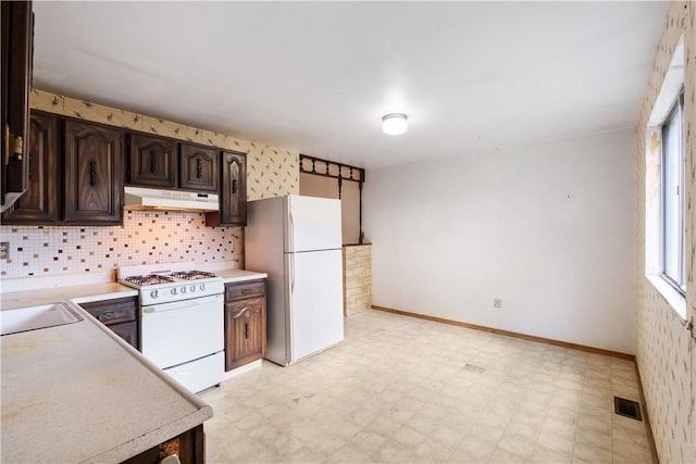 601 Dressel Rd, Shaler, PA 15101 - kitchen with white appliances, under cabinet range hood, light floors, light countertops, and dark brown cabinets