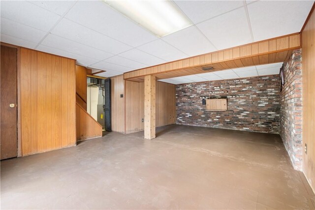 601 Dressel Rd, Shaler, PA 15101 - finished below grade area featuring brick wall, wood walls, stairway, and a drop ceiling