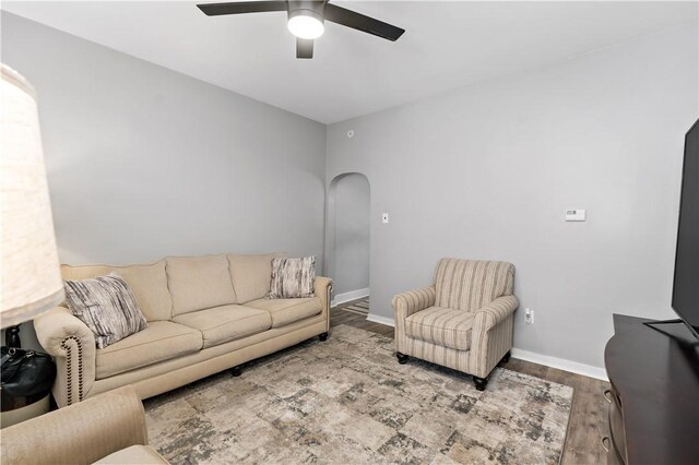 53 Sycamore St, Etna, PA 15223 - living area featuring arched walkways, a ceiling fan, wood finished floors, and baseboards
