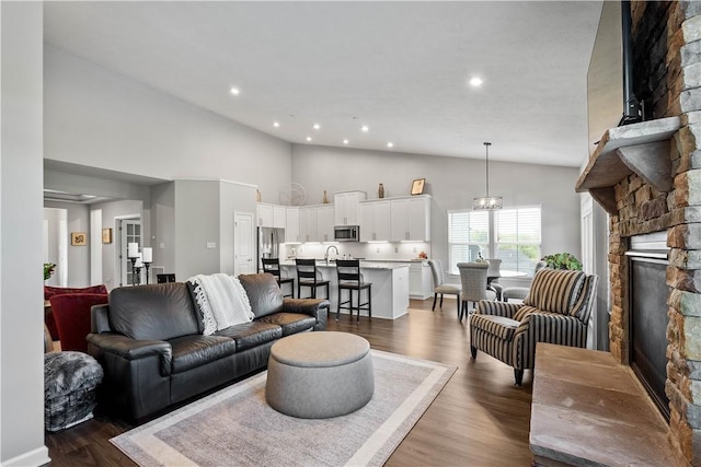 276 Regency Dr, North Strabane, PA 15330 - living room with dark wood-style flooring, high vaulted ceiling, recessed lighting, and a stone fireplace