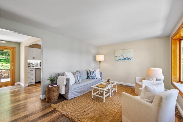 living area featuring wood finished floors and baseboards