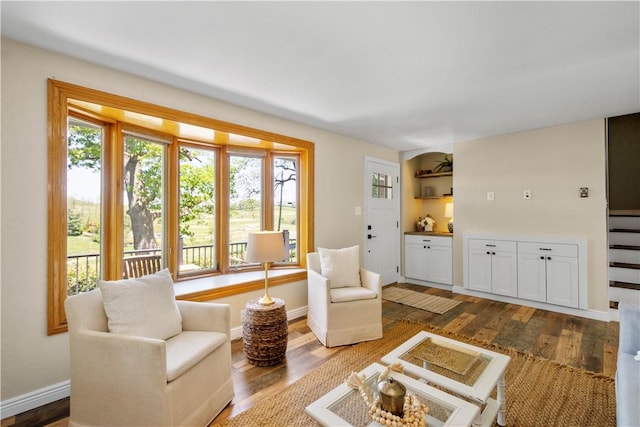 living room featuring dark wood-style floors and baseboards