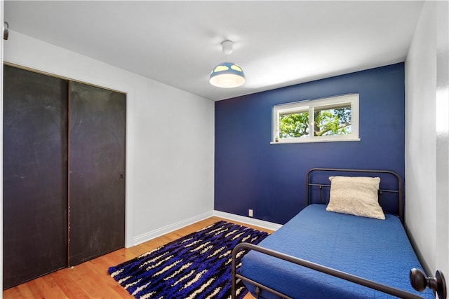 bedroom with wood finished floors and baseboards