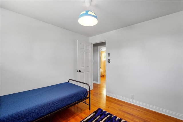 bedroom featuring light wood-style flooring and baseboards
