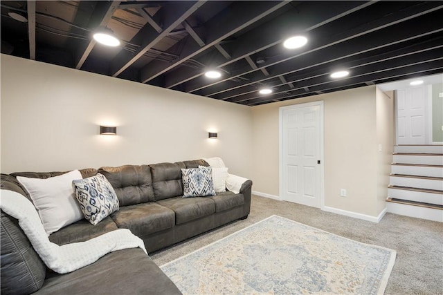living area featuring carpet, stairs, and baseboards