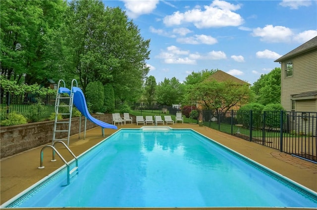 view of swimming pool featuring a water slide and fence