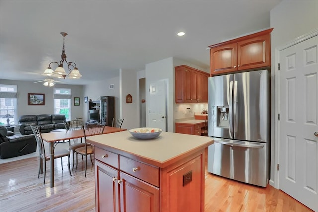 441 Settlers Village Cir, Cranberry Twp, PA 16066 - kitchen featuring stainless steel refrigerator with ice dispenser, open floor plan, a kitchen island, light wood finished floors, and a chandelier
