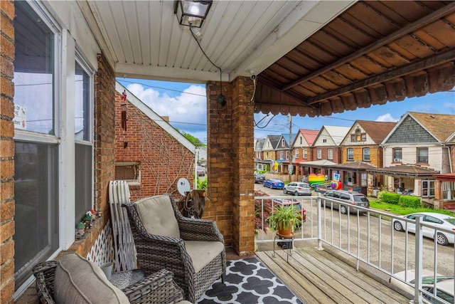 wooden deck featuring a porch and a residential view