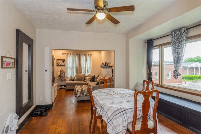 dining room featuring dark wood finished floors and ceiling fan