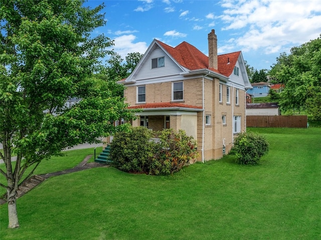 rear view of house with a chimney and brick siding